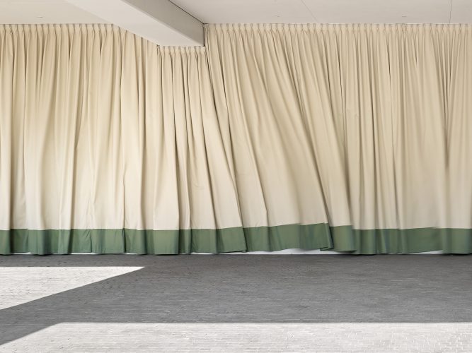 John MacLean Citybeige curtain against wall, with green trim, blows in wind. Aty photographed by London based photographer John MacLean