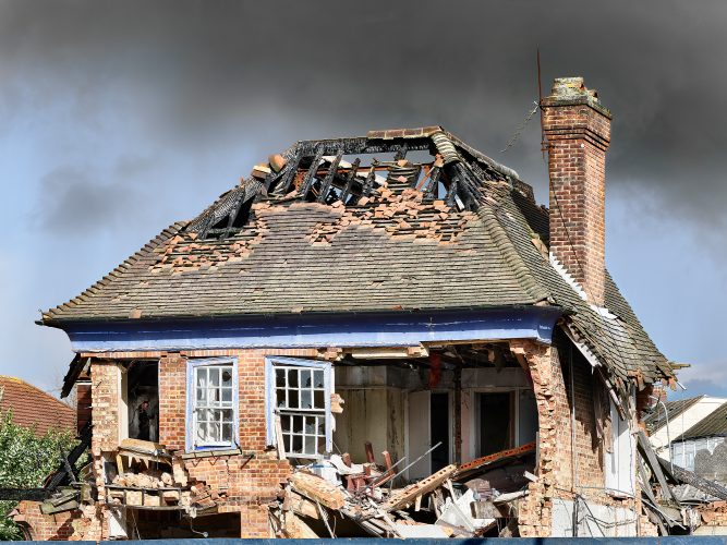 John MacLean HometownsA partially destroyed and fire-damaged derelict suburban house with broken windows and a grey sky in sculptor Phyllida Barlow’s hometown of Richmond, Surrey, UK. Created as a homage to her artistic influence, this conceptual photograph references her childhood experiences during the Blitz.