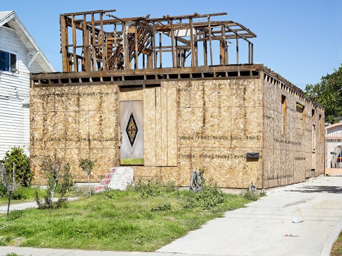 John MacLean Citypartly destroyed house in Los Angeles possibly fire damage, green lawn, steps and front door. Art photograph by John MacLean London Uk based