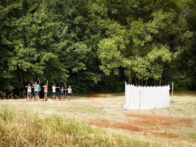 John MacLean Your NatureYoung men shoot arrows in a filed in south france. Photo by uk artists john maclean