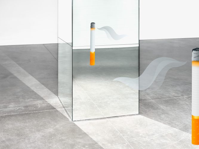 John MacLean Conversationsan emoji of a cigarette seen reflected in a mirror. Art photograph by John MacLean photographer at White Cube Gallery London UK