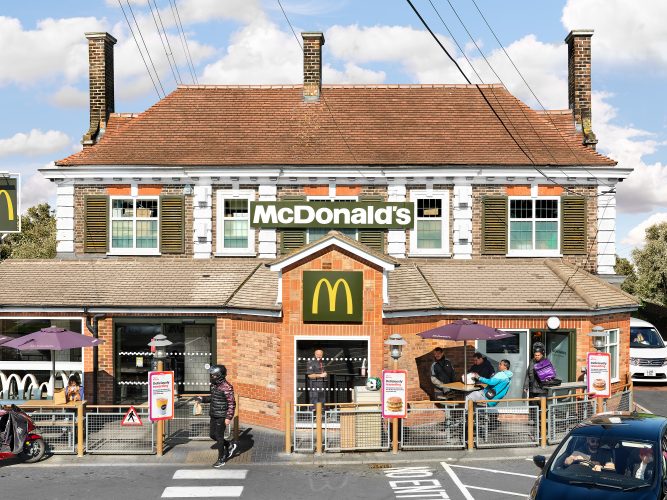John MacLean SystemA McDonald’s restaurant situated in a converted red-brick pub with three prominent chimneys in Chingford, London, UK. The building’s traditional design contrasts humorously with its adaptation for fast food, featuring large McDonald’s signage. In the foreground, delivery drivers wait with bikes, while one man wearing a helmet crosses the street holding a brown McDonald’s paper bag. The scene is set against a blue sky with scattered clouds, enhancing the surreal juxtaposition of historic architecture and modern branding